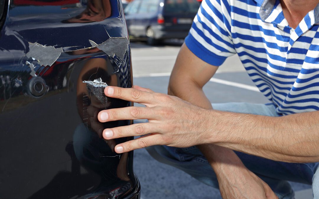 Man checking car scratches and dents
